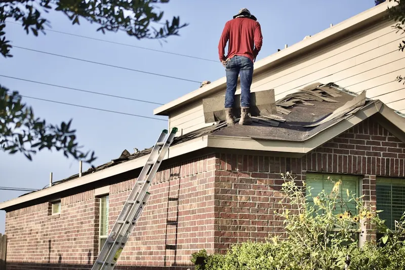 Professional roofer working on a residential roof in King Court